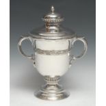 A large George V silver two-handled trophy cup and cover, leafy knop finial, fruiting laurel girdle,