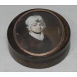 An early 19th century horn and tortoiseshell circular table snuff box, the cover set with a portrait