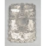 A Victorian silver shaped rectangular visiting card case, bright-cut engraved with scrolling