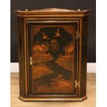 An 18th century style green japanned and chinoiserie decorated corner cabinet, moulded cornice above