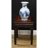A Chinese hardwood vase or jardiniere stand, panel top above a deep frieze pierced and carved with
