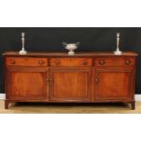 A George III mahogany low dresser or serving cabinet, slightly oversailing rectangular top with