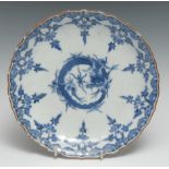 A Chinese lotus shaped dish, painted in tones of underglaze blue with a dragon, 19.5cm diam, six