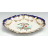 A Worcester shaped oval dessert dish, painted with an exotic bird standing beneath a leafy tree