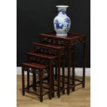 A quartet of Chinese hardwood occasional tables, each with a rectangular panel top, shaped and