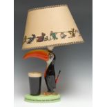 A Carlton Ware Guinness Toucan table lamp, modelled with a toucan standing before a pint of