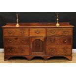 An 18th century oak low dresser, rectangular top above an arrangement of five drawers and an