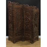 A Chinese hardwood four-fold dressing screen, boldly carved with dragons, lotus and scrolls, 193cm