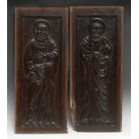 A pair of North European oak panels, each carved in relief with a saint and attribute, 62cm x