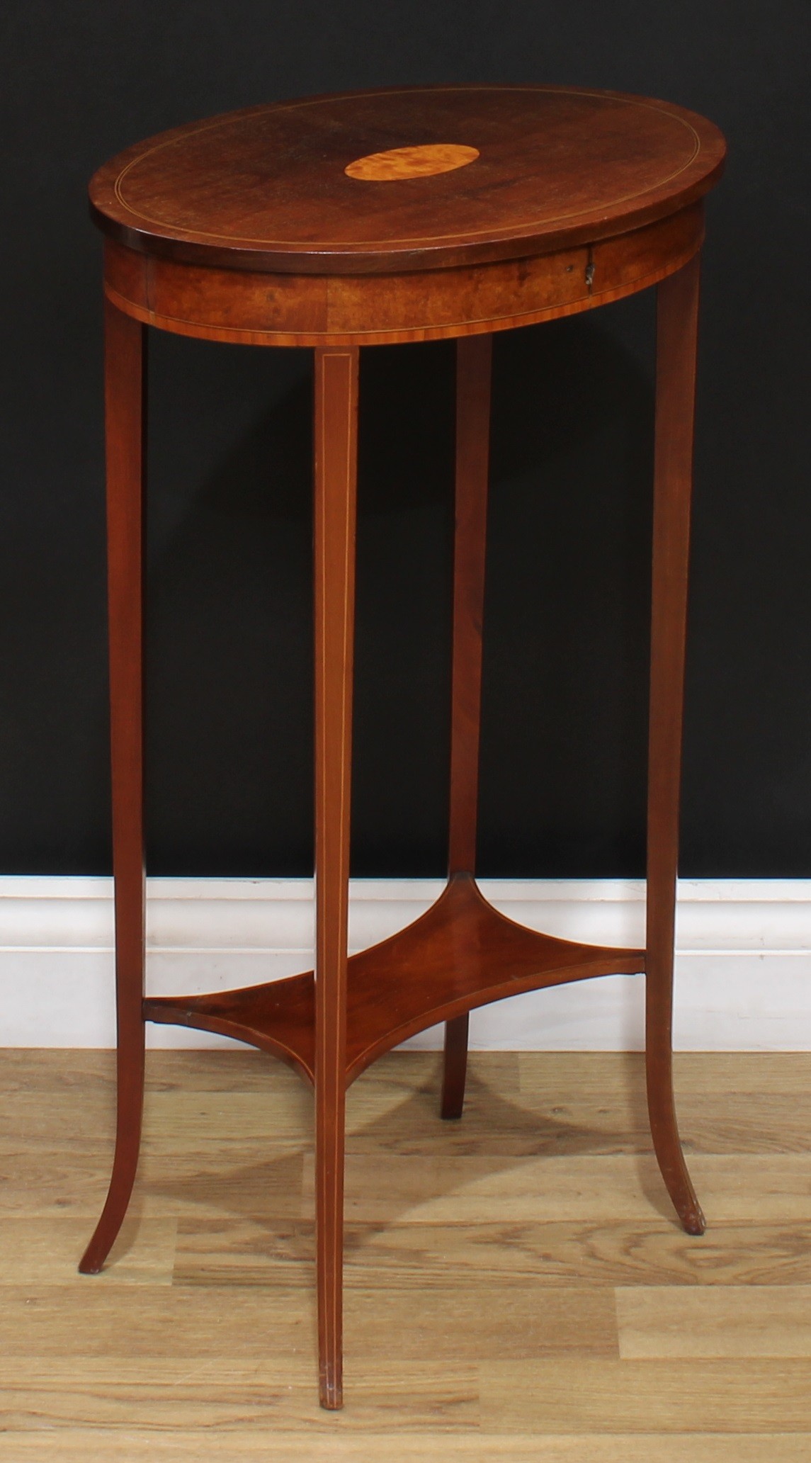 An Edwardian Sheraton Revival mahogany oval occasional table, hinged cover inlaid with a stainwood - Image 2 of 4