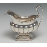 A 19th century Dutch silver half-fluted boat shaped cream jug, lofty scroll handle, domed foot, 15.