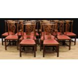 A set of twelve Provincial Chippendale Revival oak dining chairs, comprising a pair of carvers and