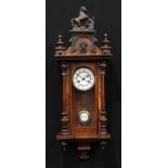 A 19th century walnut Vienna wall clock, 12.5cm enamel dial inscribed with Roman numerals, twin