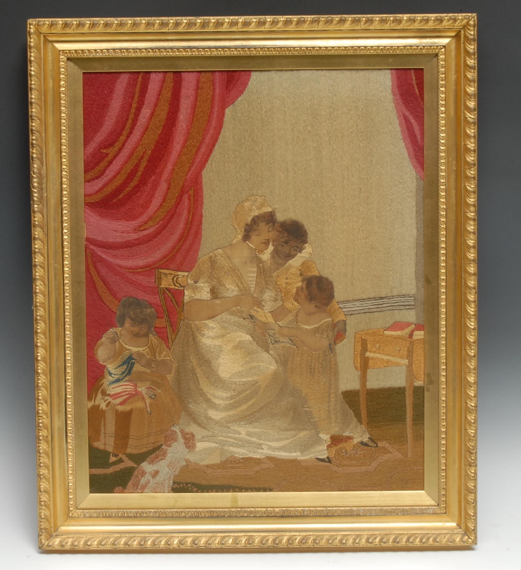 A Regency silk and needlework picture, a mother and her children in a domestic setting, one child