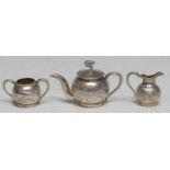 A Chinese silver miniature three piece globular tea service, comprising teapot, milk jug and sugar
