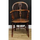 A 19th century yew and elm Windsor elbow chair, low hoop back, shaped and pierced splat, turned