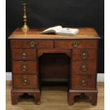 A George III oak kneehole desk, slightly oversailing rectangular top with moulded edge above an