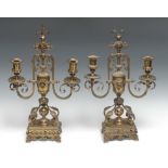 A pair of French gilt brass two-light candelabra, half-fluted campana sconces, pierced and cast