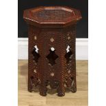 A Moorish hardwood and marquetry octagonal occasional table, dished top, carved throughout in the