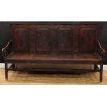 An 18th century oak settle, rectangular back with moulded cresting above four raised and fielded