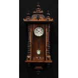 A 19th century walnut Vienna wall clock, 12.5cm enamel dial inscribed with Roman numerals, the