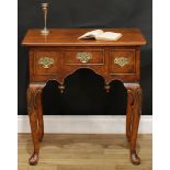 A George I style walnut lowboy, oversailing rectangular top with reentrant angles, outlined with