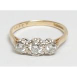 A diamond trilogy ring, linear set with three graduating round brilliant cut diamonds, total