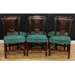 A set of six George III mahogany dining chairs, cupid's bow cresting rails carved with