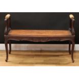 A late 19th century French window seat, shaped arms applied with manchette, rectangular cane seat,