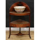 A George III mahogany corner washstand, tall gallery above three circular apertures, central