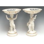 A pair of English porcelain figural comports, possibly Kerr & Bins Worcester, each modelled as a