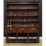 A mid-18th century oak pot-board dresser, moulded outswept cornice above three shelves, the