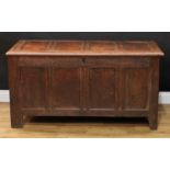 An 18th century oak blanket chest, hinged four panel top above a foliate blind fretwork frieze, re-