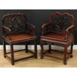 A Chinese hardwood armchair, shaped cresting rail, the back pierced and profusely carved with double