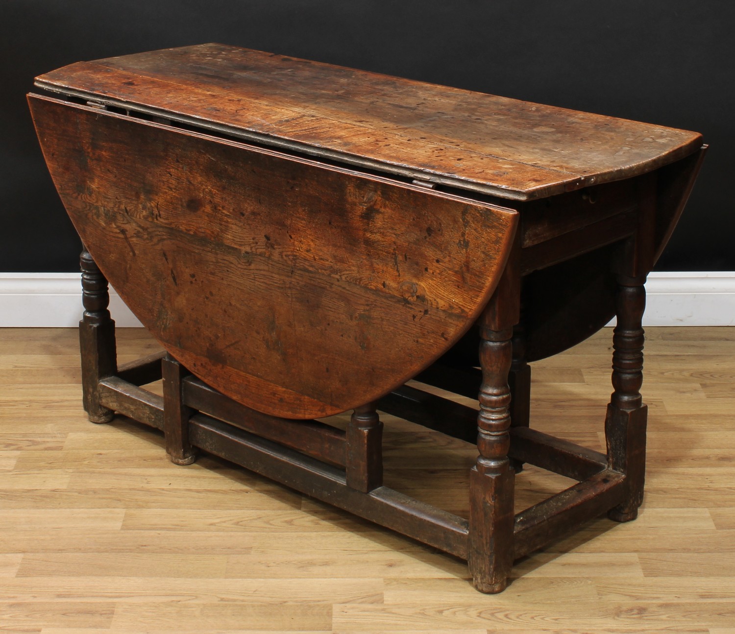 A 17th century oak gateleg table, oval top with fall leaves above a frieze drawer, turned and - Image 4 of 4