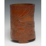 A Chinese bamboo bitong brush pot, carved in relief with two warriors, the curtained background