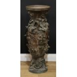A large Chinese bronze floor vase, profusely cast in relief with bands of prunus, figures riding