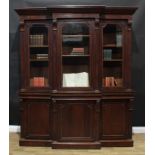 A Victorian mahogany break-centre library bookcase, outswept cornice above three glazed doors,