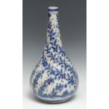 An 18th/19th century Persian bottle vase, decorated in a tin glaze with stylised slightly