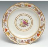 A Derby shaped circular dish, painted by George Complin, with ripe fruit and foliage within gilt