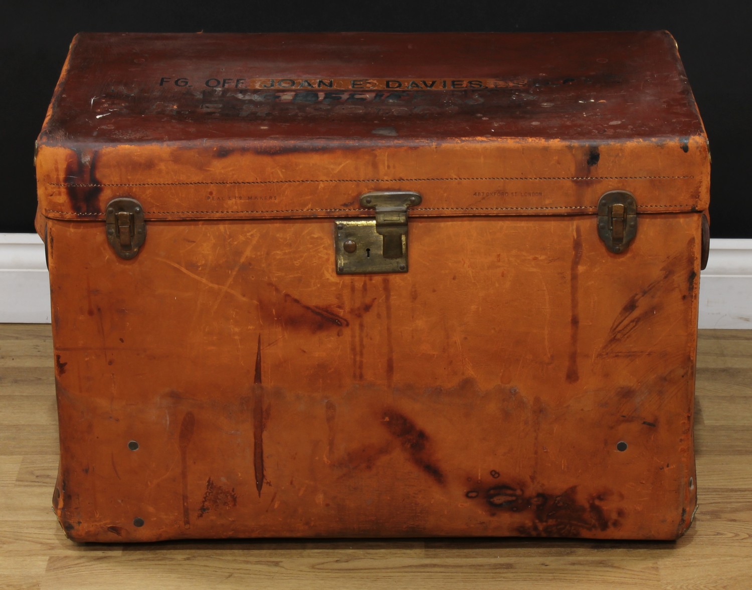 An early 20th century leather trunk, by Peal & Co Makers, 487 Oxford Street, London, carry handles