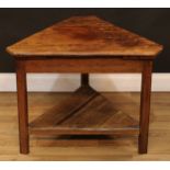 A provincial vernacular estate-made oak and elm cricket table, chamfered triangular top, open