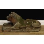 A Victorian earthenware composition garden statue, as a recumbent lion, traces of treacle glaze,