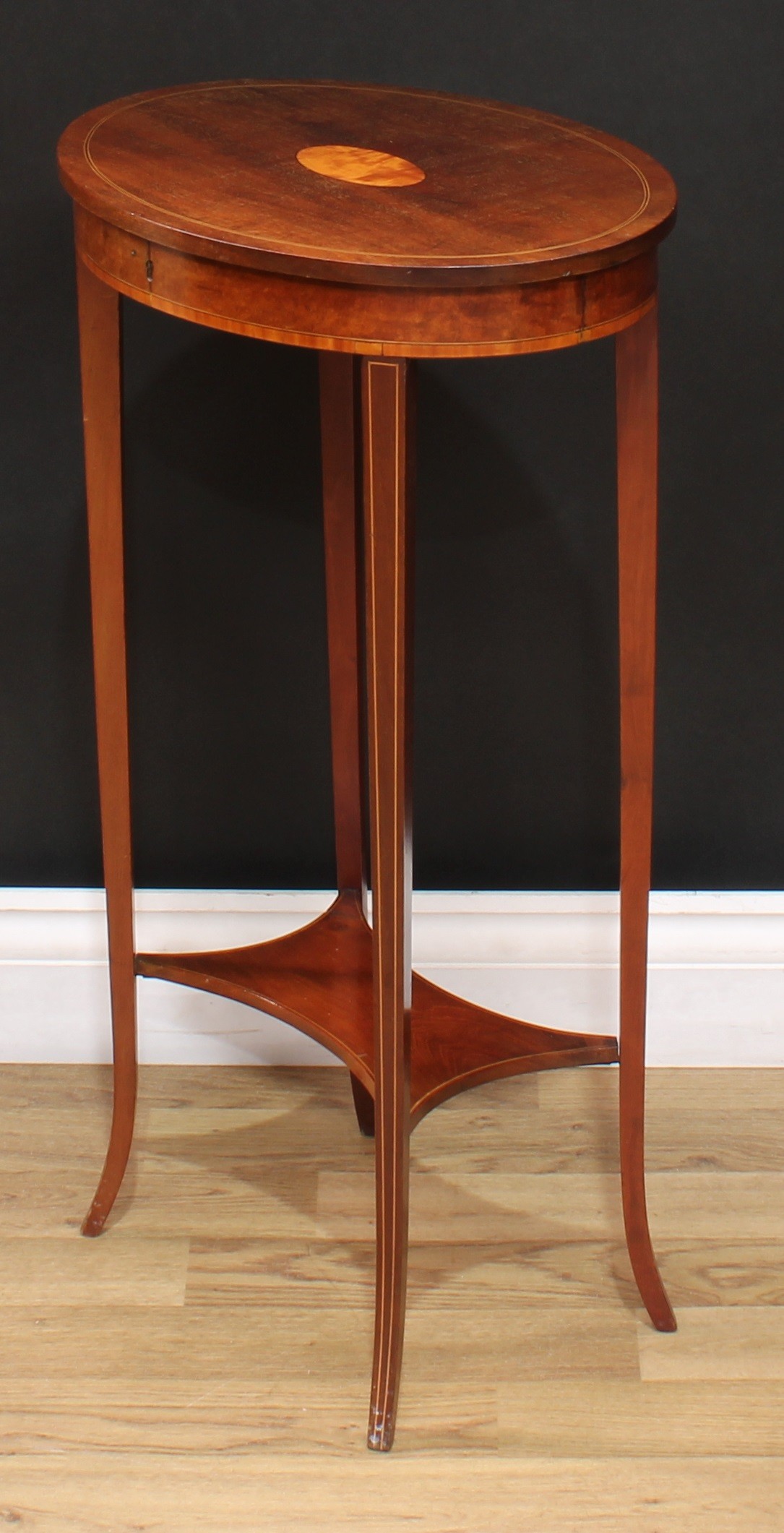 An Edwardian Sheraton Revival mahogany oval occasional table, hinged cover inlaid with a stainwood - Image 4 of 4