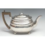 A George III silver boat shaped teapot, hinged domed cover, bright-cut engraved with a band of