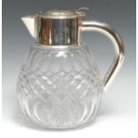 An Edwardian style silver plate mounted clear glass ovoid lemonade jug, hinged cover enclosing a
