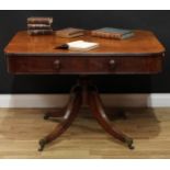 A Regency mahogany library table, rounded rectangular top with reeded edge above a frieze drawer