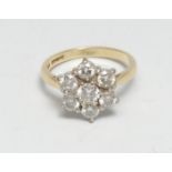 A diamond floral star cluster ring, central round brilliant cut diamond approx 0.30ct surrounded
