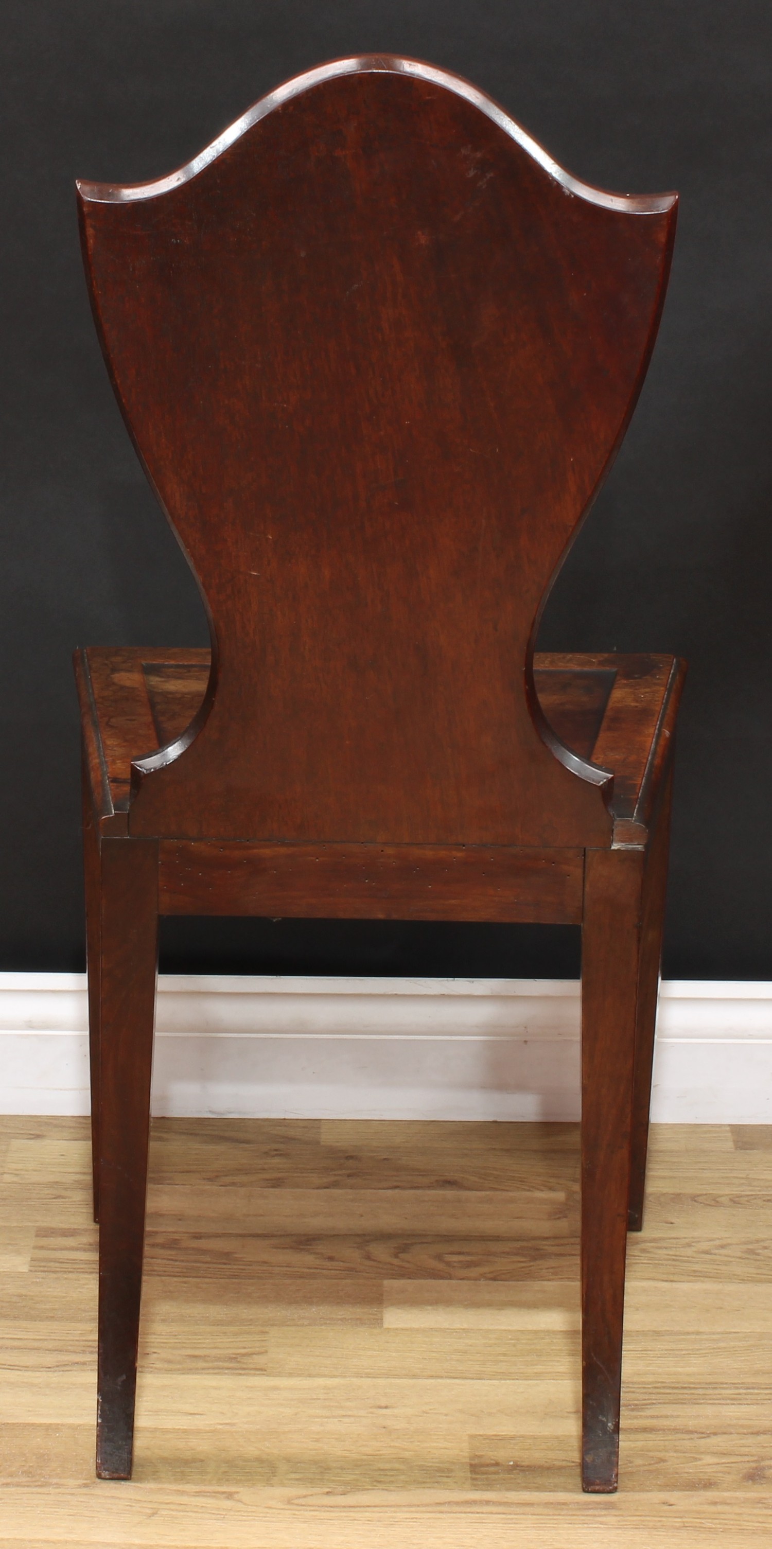 A George III mahogany Heraldic hall chair, shield shaped back with painted oval reserve, panel seat, - Image 5 of 5