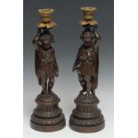A pair of 19th century French brown-patinated bronze figural candlesticks, 'caryatids' figures after
